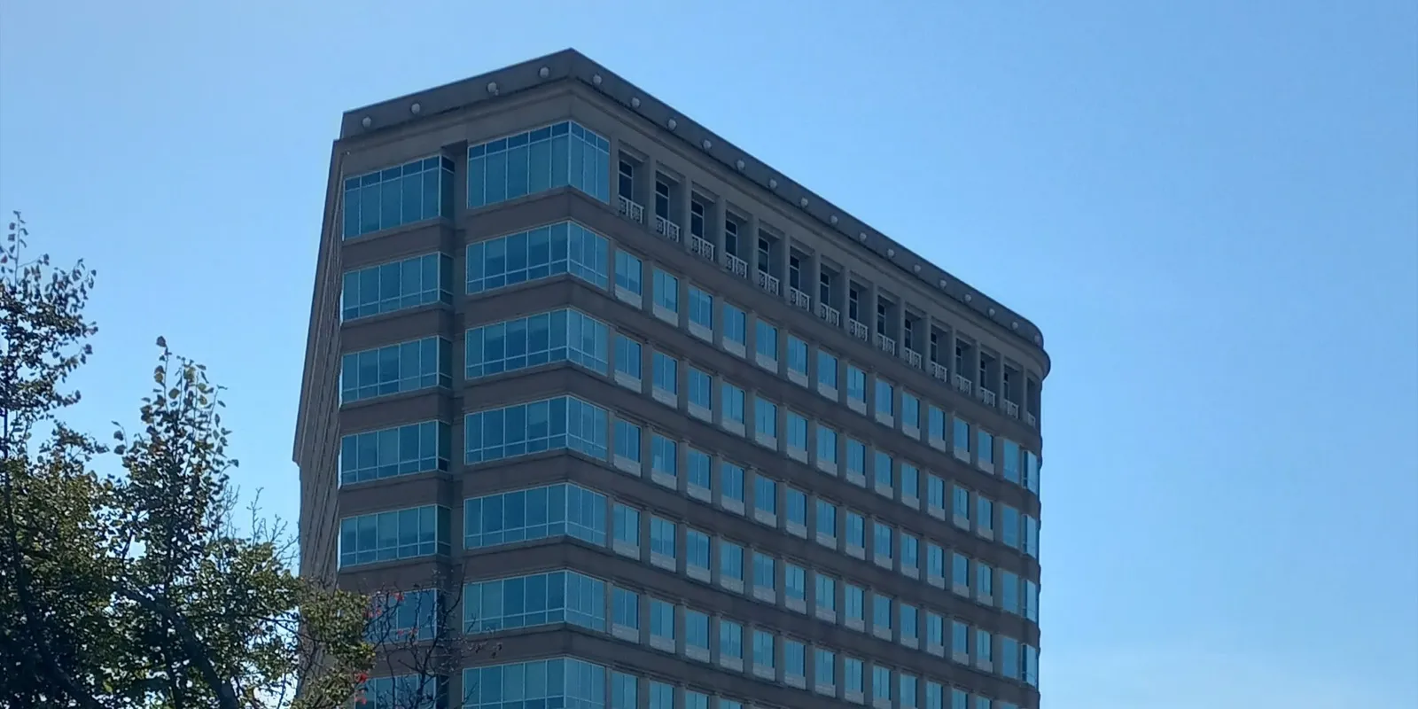 The upper floors of 55 Farmington Avenue in Hartford, the Connecticut Department of Social Services headquarters, under a clear blue sky