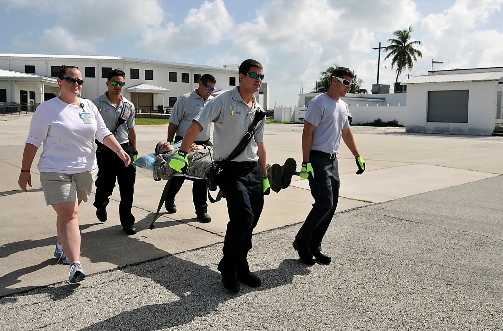 Fire and emergency services staff carry a simulated patient on a litter during a hurricane evacuation drill in Key West, Florida