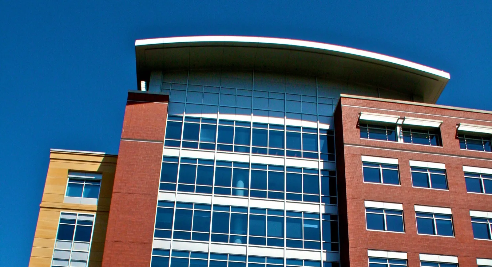 The curved roofline and upper floors of the Elmer L. Andersen Human Services Building in St. Paul, home of the Minnesota Department of Human Services