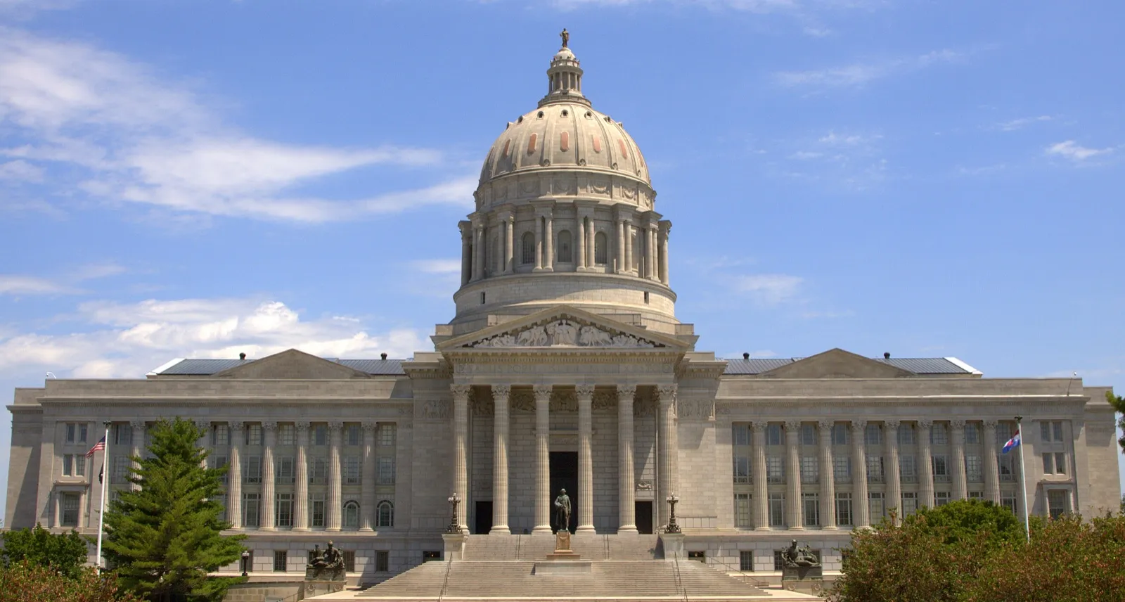 The domed Missouri State Capitol in Jefferson City and its front stairway under a blue sky with light clouds