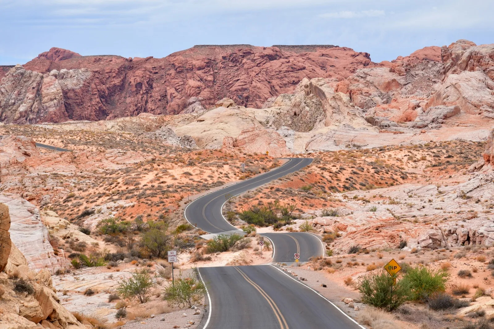 A two-lane road winding through the red and white sandstone of Valley of Fire State Park in southern Nevada