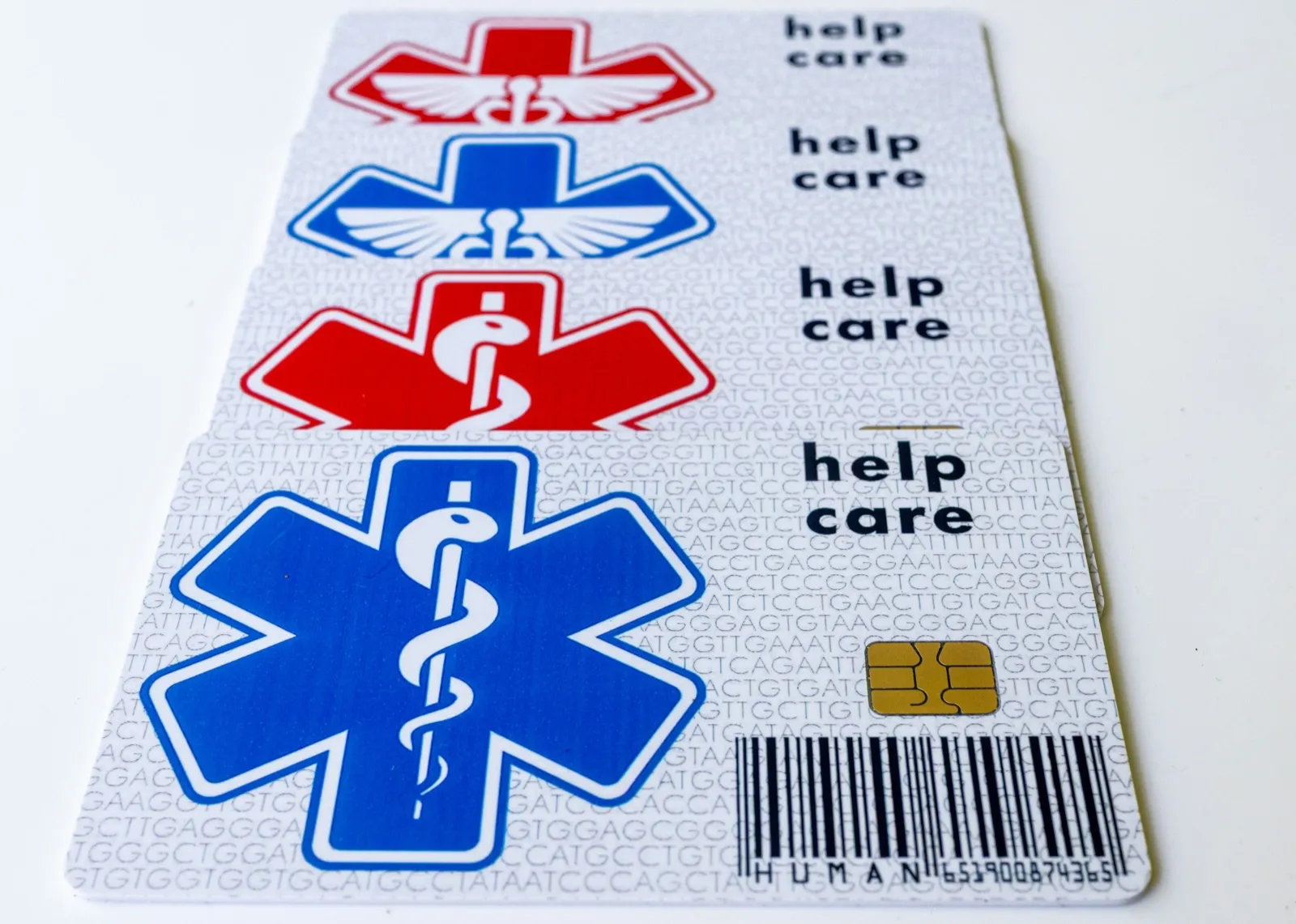Four health coverage cards fanned out on a white table, each printed with a medical symbol