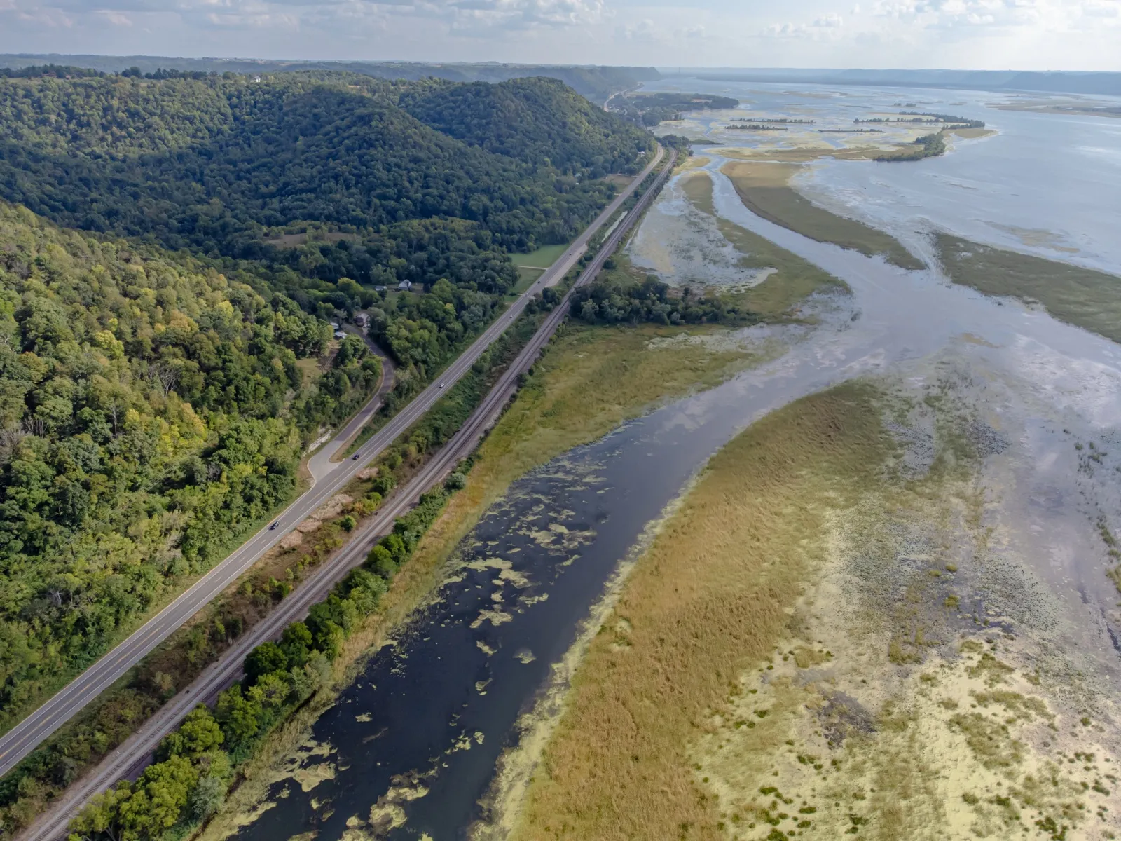 Aerial view of Wisconsin Highway 35 south of La Crosse, running between wooded bluffs and the backwaters of the Mississippi River